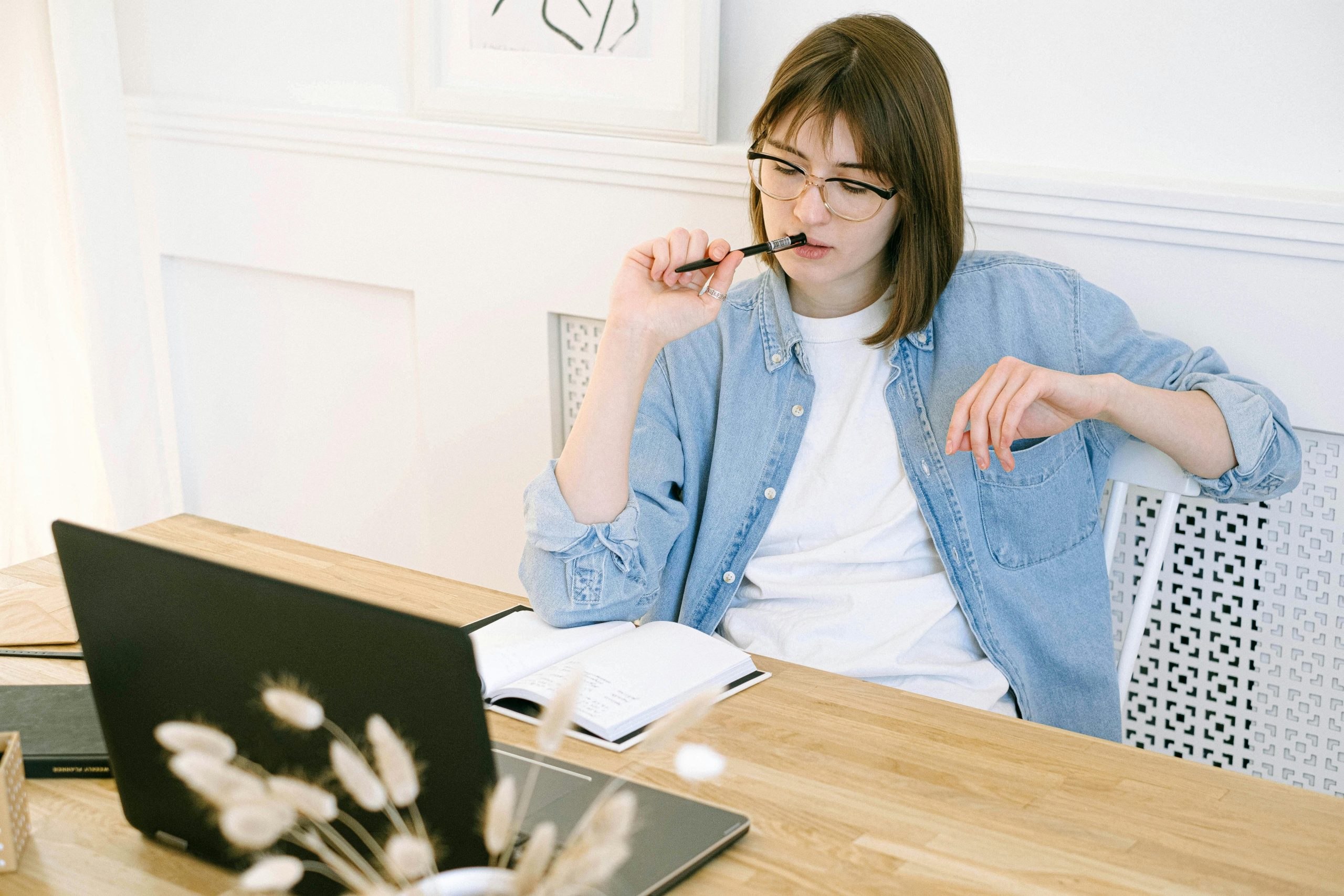 Woman at computer perplexed with challenging bookkeeping