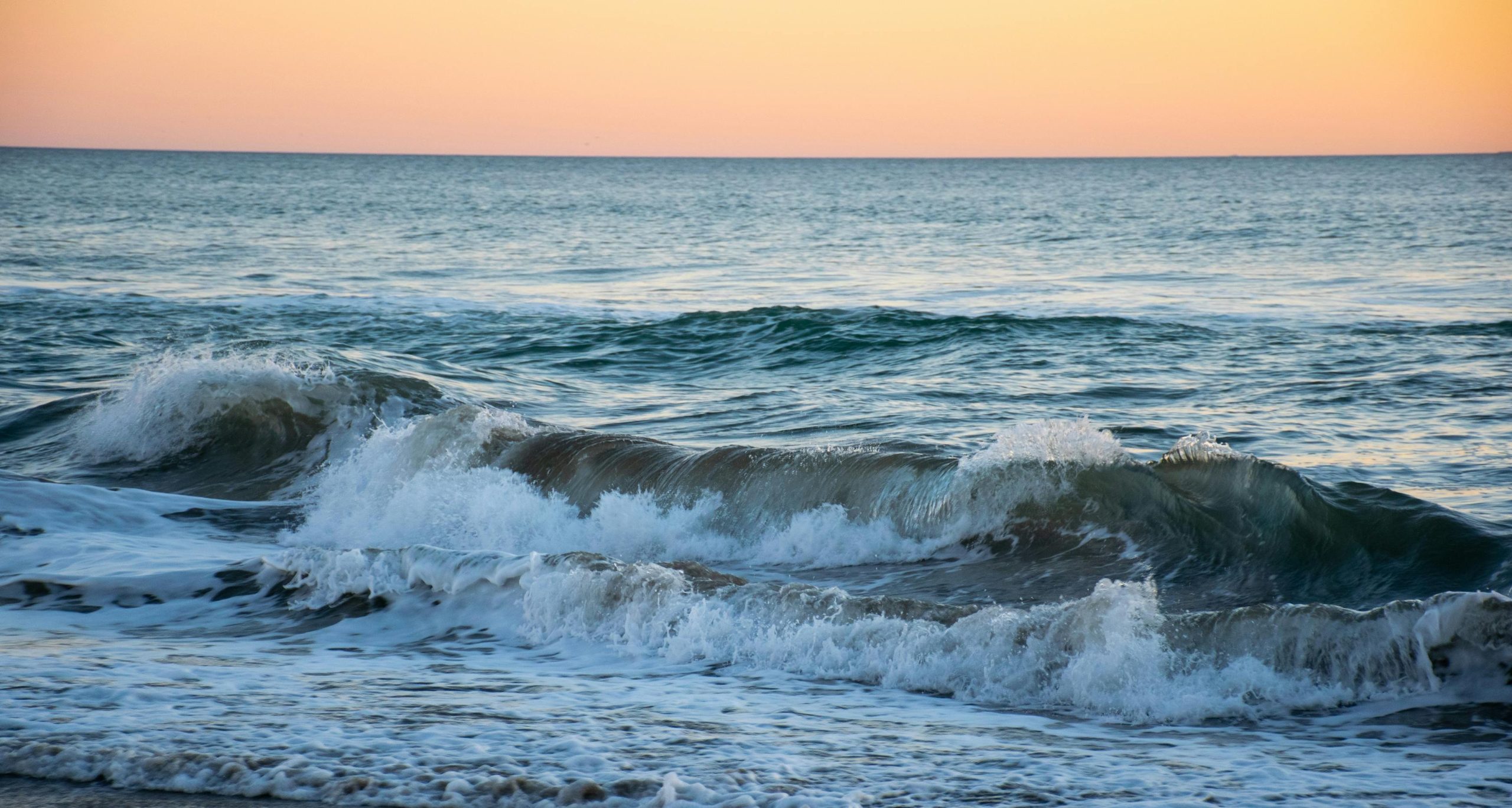 Waves flowing into shore - a reminder of how Seasonal Cash Flow Tips: Managing Your Revenue During Busy Months can help your creative business stay steady and grow.