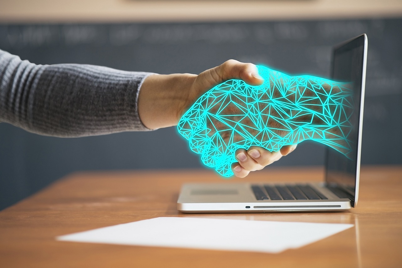 Human and digital handshake representing automation and trust in a profitable client onboarding workflow for creative professionals