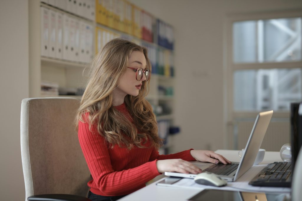 Small business owner working on laptop reviewing what books say about their business
